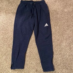 Large navy blue Adidas sweatpants.